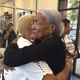 Stacie Hillsman, left, hugs Amina Baraka, mother of Mayor Ras Baraka and Shani Baraka (Angela Helm/The Root)